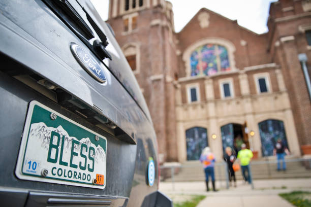 DENVER, CO - APRIL 20: A car with a "Bless" license plate parked out front at the opening of the In...