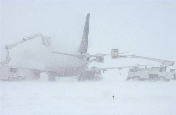 DENVER - DECEMBER 20:  De-Icing crews try to get a Continental Airlines plane clear of snow and ice...