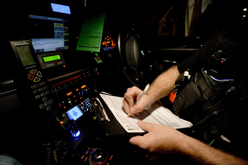 WEYMOUTH, ENGLAND - DECEMBER 06: Sgt. Jephcott from the No Excuse team writes out a ticket as he pa...