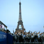 PARIS, FRANCE - JULY 26: Members of the Argentina delegation wave their national flag as they arrive at the Trocadero with the Eiffel Tower in the background during the opening ceremony of the Paris 2024 Olympic Games on July 26, 2024 in Paris, France. (Photo by Loic Venance - Pool/Getty Images)