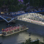 PARIS, FRANCE - JULY 26: Athletes travel by boat down the Seine River during the Opening Ceremony of the Olympic Games Paris 2024 on July 26, 2024 in Paris, France. (Photo by Petr David Josek-Pool/Getty Images)