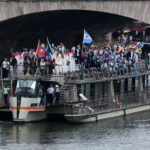 PARIS, FRANCE - JULY 26: Team Antigua and Bermuda, Team Saudi Arabia, Team Argentina, Team Armenia and Team Aruba are seen on a boat on the River Seine during the opening ceremony of the Olympic Games Paris 2024 on July 26, 2024 in Paris, France. (Photo by Christian Petersen/Getty Images)