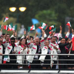 PARIS, FRANCE - JULY 26: Emiliano Hernandez and Alejandra Orozco Loza, Flagbearers of Team Mexico, are seen on a boat waving their flag along the River Seine during the opening ceremony of the Olympic Games Paris 2024 on July 26, 2024 in Paris, France. (Photo by Kevin C. Cox/Getty Images)