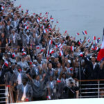 PARIS, FRANCE - JULY 26: Members of Team France react as they are seen on a boat on the River Seine during the opening ceremony of the Olympic Games Paris 2024 on July 26, 2024 in Paris, France. (Photo by Lars Baron/Getty Images)