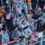 PARIS, FRANCE - JULY 26: Athletes of Team United States are seen waving their hand held flags on a boat along the River Seine during the opening ceremony of the Olympic Games Paris 2024 on July 26, 2024 in Paris, France. (Photo by Alex Pantling/Getty Images)