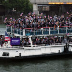 PARIS, FRANCE - JULY 26: Athletes of Team United States wave flags on the athletes' parade team boat along the River Seine  during the opening ceremony of the Olympic Games Paris 2024 on July 26, 2024 in Paris, France. (Photo by Jared C. Tilton/Getty Images)