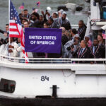 PARIS, FRANCE - JULY 26: Athletes of Team United States wave flags on the athletes' parade team boat along the River Seine  during the opening ceremony of the Olympic Games Paris 2024 on July 26, 2024 in Paris, France. (Photo by Jared C. Tilton/Getty Images)