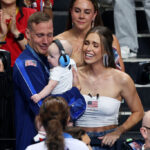 NANTERRE, FRANCE - JULY 27: Gold Medalist, Caeleb Dressel of Team United States celebrates with his wife, Meghan Dressel, and his child, following the Medal Ceremony after the Men's 4x100m Freestyle Relay Final on day one of the Olympic Games Paris 2024 at Paris La Defense Arena on July 27, 2024 in Nanterre, France. (Photo by Quinn Rooney/Getty Images)