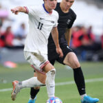 MARSEILLE, FRANCE - JULY 27: Paxten Aaronson #11 of Team United States is challenged by Tyler Bindon #4 of Team New Zealand during the Men's group A match between New Zealand and United States during the Olympic Games Paris 2024 at Stade de Marseille on July 27, 2024 in Marseille, France. (Photo by Alex Livesey/Getty Images)