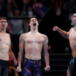 NANTERRE, FRANCE - JULY 27: Chris Guiliano, Hunter Armstrong and Jack Alexy of Team United States celebrate after winning gold in the Men's 4x100m Freestyle Relay Final on day one of the Olympic Games Paris 2024 at Paris La Defense Arena on July 27, 2024 in Nanterre, France. (Photo by Maddie Meyer/Getty Images)