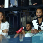 PARIS, FRANCE - JULY 28: Chrissy Teigen, her husband John Legend and their son Miles attend the Artistic Gymnastics Women's Qualification on day two of the Olympic Games Paris 2024 at Bercy Arena on July 28, 2024 in Paris, France. (Photo by Arturo Holmes/Getty Images)