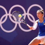 PARIS, FRANCE - JULY 28: Sara Errani of Team Italy plays a forehand against Qinwen Zhang of Team People's Republic of China during the Women’s Singles/ first round match on day two of the Olympic Games Paris 2024 at Roland Garros on July 28, 2024 in Paris, France. (Photo by Matthew Stockman/Getty Images)