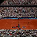 PARIS, FRANCE - JULY 28: A general view as Rafael Nadal of Team Spain plays a backhand against Marton Fucsovics of Team Hungary during the Men’s Singles first round match on day two of the Olympic Games Paris 2024 at Roland Garros on July 28, 2024 in Paris, France. (Photo by Clive Brunskill/Getty Images)