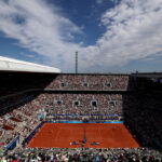 PARIS, FRANCE - JULY 28: A general view Rafael Nadal of Team Spain plays a forehand against Marton Fucsovics of Team Hungary during the Men’s Singles first round match on day two of the Olympic Games Paris 2024 at Roland Garros on July 28, 2024 in Paris, France. (Photo by Clive Brunskill/Getty Images)