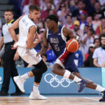 LILLE, FRANCE - JULY 28: Anthony Edwards #5 of Team United States drives to the basket against Bogdan Bogdanovic #7 of Team Serbia during the first half of the Men's Group Phase - Group C game between Serbia and the United States on day two of the Olympic Games Paris 2024 at Stade Pierre Mauroy on July 28, 2024 in Lille, France. (Photo by Gregory Shamus/Getty Images)