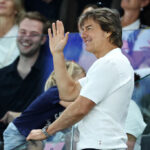 PARIS, FRANCE - JULY 28: Tom Cruise waves during the Artistic Gymnastics Women's Qualification on day two of the Olympic Games Paris 2024 at Bercy Arena on July 28, 2024 in Paris, France. (Photo by Arturo Holmes/Getty Images)