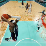 LILLE, FRANCE - JULY 28: (EDITORS NOTE: Image was captured using a remote camera) Bam Adebayo #13 of Team United States dunks the ball during the second half of the Men's Group Phase - Group C game between Serbia and the United States on day two of the Olympic Games Paris 2024 at Stade Pierre Mauroy on July 28, 2024 in Lille, France. (Photo by Gregory Shamus/Getty Images)