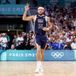 LILLE, FRANCE - JULY 28: Devin Booker #15 of Team United States reacts to a three point basket during the second half of the Men's Group Phase - Group C game between Serbia and the United States on day two of the Olympic Games Paris 2024 at Stade Pierre Mauroy on July 28, 2024 in Lille, France. (Photo by Gregory Shamus/Getty Images)