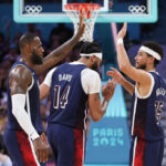 LILLE, FRANCE - JULY 28: Lebron James #6 high fives Devin Booker #15 of Team United States during the second half of the Men's Group Phase - Group C game between Serbia and the United States on day two of the Olympic Games Paris 2024 at Stade Pierre Mauroy on July 28, 2024 in Lille, France. (Photo by Gregory Shamus/Getty Images)