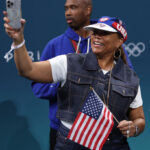 LILLE, FRANCE - JULY 28: American performer Queen Latifah takes a photo during the second half of the Men's Group Phase - Group C game between Serbia and the United States on day two of the Olympic Games Paris 2024 at Stade Pierre Mauroy on July 28, 2024 in Lille, France. (Photo by Gregory Shamus/Getty Images)