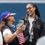 LILLE, FRANCE - JULY 28: American performer Queen Latifah talks with basketball player A'ja Wilson of Team United States during the second half of the Men's Group Phase - Group C game between Serbia and the United States on day two of the Olympic Games Paris 2024 at Stade Pierre Mauroy on July 28, 2024 in Lille, France. (Photo by Gregory Shamus/Getty Images)