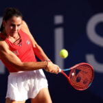 PARIS, FRANCE - JULY 28: Emma Navarro of Team United States plays a backhand against Julia Grabher of Team Austria during the Women’s Singles first round match on day two of the Olympic Games Paris 2024 at Roland Garros on July 28, 2024 in Paris, France. (Photo by Matthew Stockman/Getty Images)