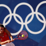 PARIS, FRANCE - JULY 28: Emma Navarro of Team United States plays a backhand against Julia Grabher of Team Austria during the Women’s Singles first round match on day two of the Olympic Games Paris 2024 at Roland Garros on July 28, 2024 in Paris, France. (Photo by Matthew Stockman/Getty Images)