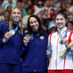 NANTERRE, FRANCE - JULY 28: Gold Medalist Torri Huske (C) and Silver Medalist Gretchen Walsh (L) of Team United States and Bronze Medalist Yufei Zhang of Team People's Republic of China (R) pose on the podium during the Swimming medal ceremony after the Women’s 100m Butterfly Final on day two of the Olympic Games Paris 2024 at Paris La Defense Arena on July 28, 2024 in Nanterre, France. (Photo by Quinn Rooney/Getty Images)