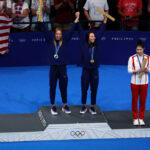 NANTERRE, FRANCE - JULY 28: (EDITORS NOTE: Image was captured using a robotic camera positioned above the field of play.) Gold Medalist Torri Huske (C) and Silver Medalist Gretchen Walsh (L) of Team United States celebrate on the podium alongside Bronze Medalist Yufei Zhang of Team People's Republic of China (R) during the Swimming medal ceremony after the Women’s 100m Butterfly Final on day two of the Olympic Games Paris 2024 at Paris La Defense Arena on July 28, 2024 in Nanterre, France. (Photo by Richard Heathcote/Getty Images)