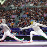 PARIS, FRANCE - JULY 29: Misaki Emura of Team Japan (L) and  Olena Kravatska of Team Ukraine (R) compete in the Fencing Women's Sabre Individual Table of 32 on day three of the Olympic Games Paris 2024 at Grand Palais on July 29, 2024 in Paris, France. (Photo by Carl Recine/Getty Images)