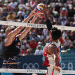 PARIS, FRANCE - JULY 29: Chase Budinger of Team United States and Youssef Krou of Team France attack the net during the Men's Preliminary Phase - Pool F match on day three of the Olympic Games Paris 2024 at Eiffel Tower Stadium on July 29, 2024 in Paris, France. (Photo by Michael Reaves/Getty Images)