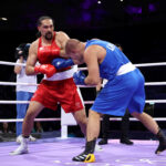 PARIS, FRANCE - JULY 29: Dmytro Lovchynskyi of Team Ukraine punches Teremoana Teremoana of Team Australia during the Men's +92kg preliminary round match between Teremoana Teremoana of Team Australia and Dmytro Lovchynskyi of Team Ukraine on day three of the Olympic Games Paris 2024 at North Paris Arena on July 29, 2024 in Paris, France. (Photo by Richard Pelham/Getty Images)