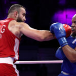 PARIS, FRANCE - JULY 29: Mourad Kadi of Team Algeria punches  Djamili-Dini Aboudou Moindze of Team France during the Men's +92kg preliminary round match between Mourad Kadi of Team Algeria and Djamili-Dini Aboudou Moindze of Team France on day three of the Olympic Games Paris 2024 at North Paris Arena on July 29, 2024 in Paris, France. (Photo by Richard Pelham/Getty Images)