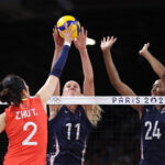 PARIS, FRANCE - JULY 29: Ting Zhu #2 of Team People's Republic of China attacks the net against Andrea Drews #11 and Chiaka Ogbogu #24 of Team United States during the Women's Preliminary Round - Pool A match between the United States and China on day three of the Olympic Games Paris 2024 at Paris Arena on July 29, 2024 in Paris, France. (Photo by Christian Petersen/Getty Images)