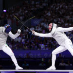 PARIS, FRANCE - JULY 29: Filippo Macchi of team Italy (L) and Nick Itkin of United States compete in the Fencing Men's Foil Individual Semifinal 2 on day three of the Olympic Games Paris 2024 at Grand Palais on July 29, 2024 in Paris, France. (Photo by Al Bello/Getty Images)