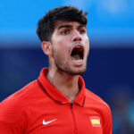 PARIS, FRANCE - JULY 29: Carlos Alcaraz of Team Spain reacts against Tallon Griekspoor of Team Netherlands during the Men's Singles second round match on day three of the Olympic Games Paris 2024 at Roland Garros on July 29, 2024 in Paris, France. (Photo by Clive Brunskill/Getty Images)