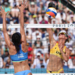 PARIS, FRANCE - JULY 30: Monika Paulikiene of Team Lithuania attacks the net against Carolina Solberg Salgado of Team Brazil during the Women's Preliminary Phase - Pool E match on day four of the Olympic Games Paris 2024 at Eiffel Tower Stadium on July 30, 2024 in Paris, France. (Photo by Lintao Zhang/Getty Images)