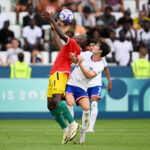 SAINT-ETIENNE, FRANCE - JULY 30: Ousmane Camara #11 of Team Guinea battles for possession with Paxten Aaronson #11 of Team USA during the Men's group A match between United States and Guinea during the Olympic Games Paris 2024 at Stade Geoffroy-Guichard on July 30, 2024 in Saint-Etienne, France. (Photo by Tullio M. Puglia/Getty Images)