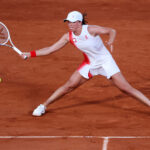 PARIS, FRANCE - JULY 30: Iga Swiatek of Team Poland plays a forehand against Xiyu Wang of People's Republic of China during the Women's Singles third round match on day four of the Olympic Games Paris 2024 at Roland Garros on July 30, 2024 in Paris, France. (Photo by Matthew Stockman/Getty Images)