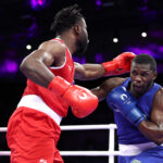 PARIS, FRANCE - JULY 30: Wanderley de Souza Pereira of Team Brazil punches Cedrick Belony-Duliepre of Team Haiti during the Men's 80kg preliminary round match between Cedrick Belony-Duliepre of Team Haiti and Wanderley de Souza Pereira of Team Brazil on day four of the Olympic Games Paris 2024 at North Paris Arena on July 30, 2024 in Paris, France. (Photo by Richard Pelham/Getty Images)