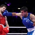 PARIS, FRANCE - AUGUST 01: Ruslan Abdullaev of Team Uzbekistan punches Wyatt Sanford of Team Canada during the Men's 63.5kg preliminary round match on day six of the Olympic Games Paris 2024 at North Paris Arena on August 01, 2024 in Paris, France. (Photo by Richard Pelham/Getty Images)