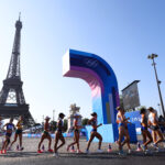 PARIS, FRANCE - AUGUST 01: Athletes compete as the Eiffel Tower is seen in the background during the Women’s 20km Race Walk on day six of the Olympic Games Paris 2024 at Trocadero on August 01, 2024 in Paris, France. (Photo by Christian Petersen/Getty Images)