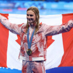 NANTERRE, FRANCE - AUGUST 01: Gold Medalist Summer McIntosh of Team Canada poses with the national flag of Canada following the Swimming medal ceremony after the Women's 200m Butterfly Final on day six of the Olympic Games Paris 2024 at Paris La Defense Arena on August 01, 2024 in Nanterre, France. (Photo by Maddie Meyer/Getty Images)