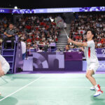 PARIS, FRANCE - AUGUST 01: Yuta Watanabe and Arisa Higashino of Team Japan compete during a Mixed Doubles Semifinal match against Team People’s Republic of China on day six of the Olympic Games Paris 2024 at Porte de La Chapelle Arena on August 01, 2024 in Paris, France. (Photo by Michael Reaves/Getty Images)