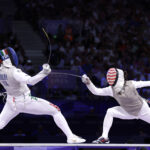 PARIS, FRANCE - AUGUST 01: Alice Volpi of Team Italy (L) and Lee Kiefer of Team United States compete during the Women's Foil Team Gold Medal Match Bout between Team Italy and Team United States on day six of the Olympic Games Paris 2024 at Grand Palais on August 01, 2024 in Paris, France. (Photo by Clive Brunskill/Getty Images)