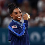 PARIS, FRANCE - AUGUST 01: Gold medalist Simone Biles of Team United States poses with her medal after competing in the Artistic Gymnastics Women's All-Around Final on day six of the Olympic Games Paris 2024 at Bercy Arena on August 01, 2024 in Paris, France. (Photo by Naomi Baker/Getty Images)