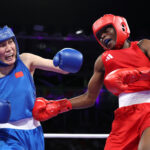 PARIS, FRANCE - AUGUST 01: Alcinda Lucas Dos Santos of Team Mozambique and Liu Yang of Team People's Republic of China exchange punches during the Women's 66kg preliminary round match on day six of the Olympic Games Paris 2024 at North Paris Arena on August 01, 2024 in Paris, France. (Photo by Richard Pelham/Getty Images)