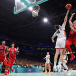 LILLE, FRANCE - AUGUST 01: (EDITORS NOTE: Image was captured using a remote camera)  Sabrina Ionescu #6 of Team United States shoots over Kyara Linskens #13 of Team Belgium during a Women's Basketball Group Phase - Group C game between the United States and Belgium on day six of the Olympic Games Paris 2024 at Stade Pierre Mauroy on August 01, 2024 in Lille, France. (Photo by Gregory Shamus/Getty Images)