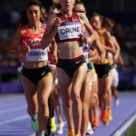 PARIS, FRANCE - AUGUST 02: Agate Caune of Team Latvia anNozomi Tanaka of Team Japan  compete during the Women's 5000 Metres heats on day seven of the Olympic Games Paris 2024 at Stade de France on August 02, 2024 in Paris, France. (Photo by Cameron Spencer/Getty Images)