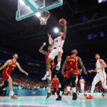 LILLE, FRANCE - AUGUST 02: (EDITORS NOTE: Image was captured using a remote camera) Andrew Nembhard #19 of Team Canada goes up for a basket past Juancho Hernangomez #10 and Lorenzo Brown #2 of Team Spain during the Men's Group Phase - Group A game between Team Canada and Team Spain on day seven of the Olympic Games Paris 2024 at Stade Pierre Mauroy on August 02, 2024 in Lille, France. (Photo by Gregory Shamus/Getty Images)